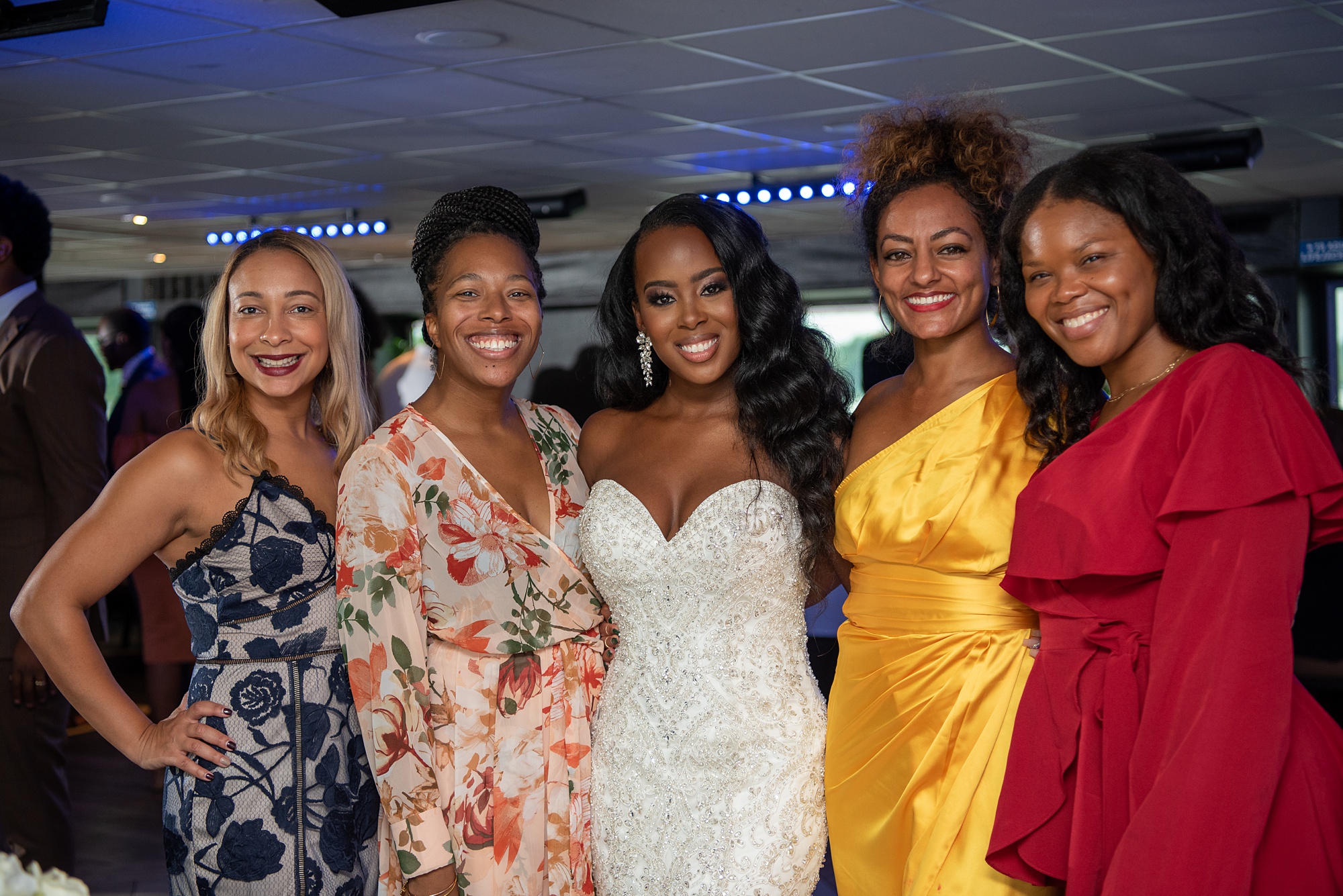 bride poses with guests during DC wedding reception