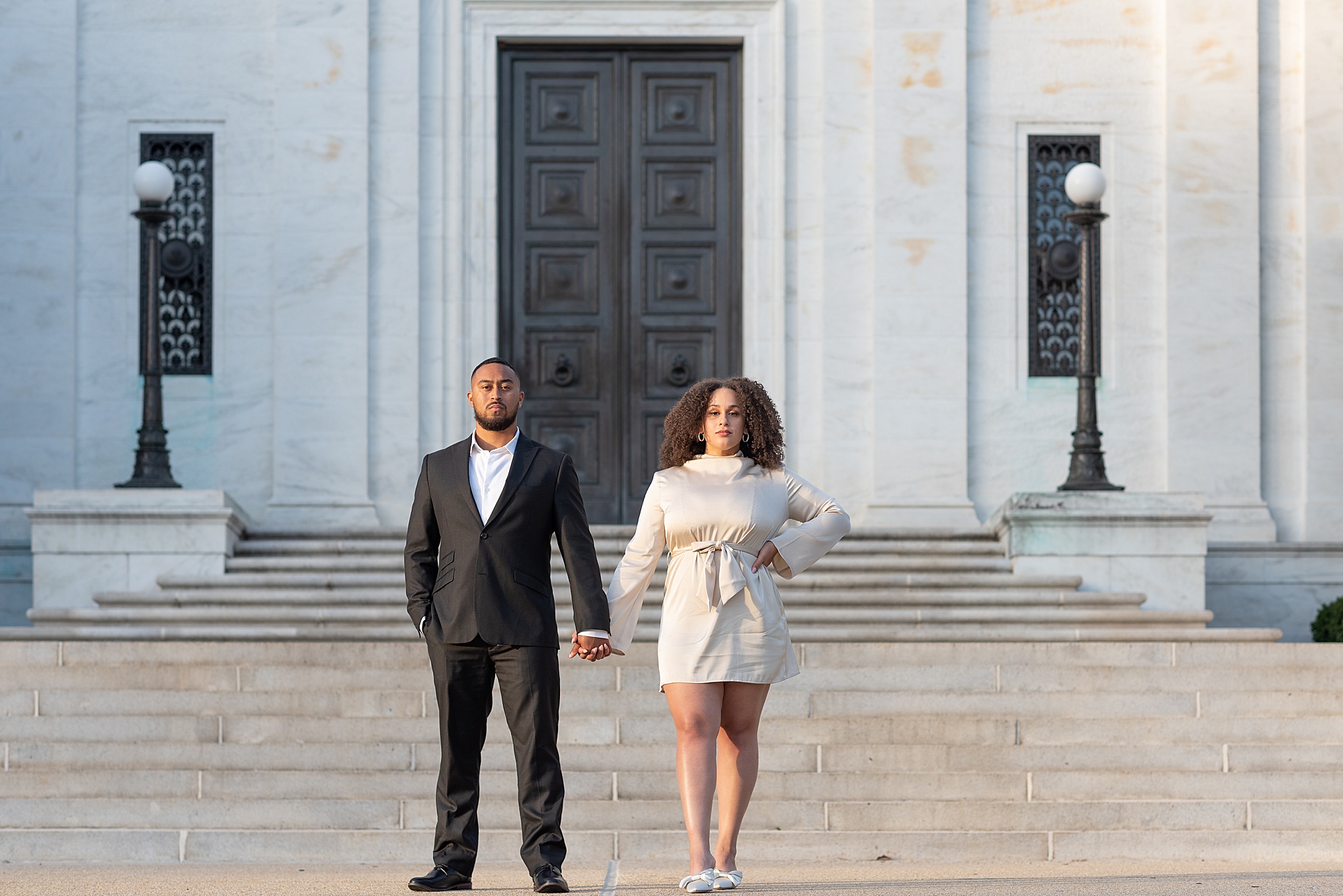 bride and groom hold hands standing outside the American Pharmacist Association