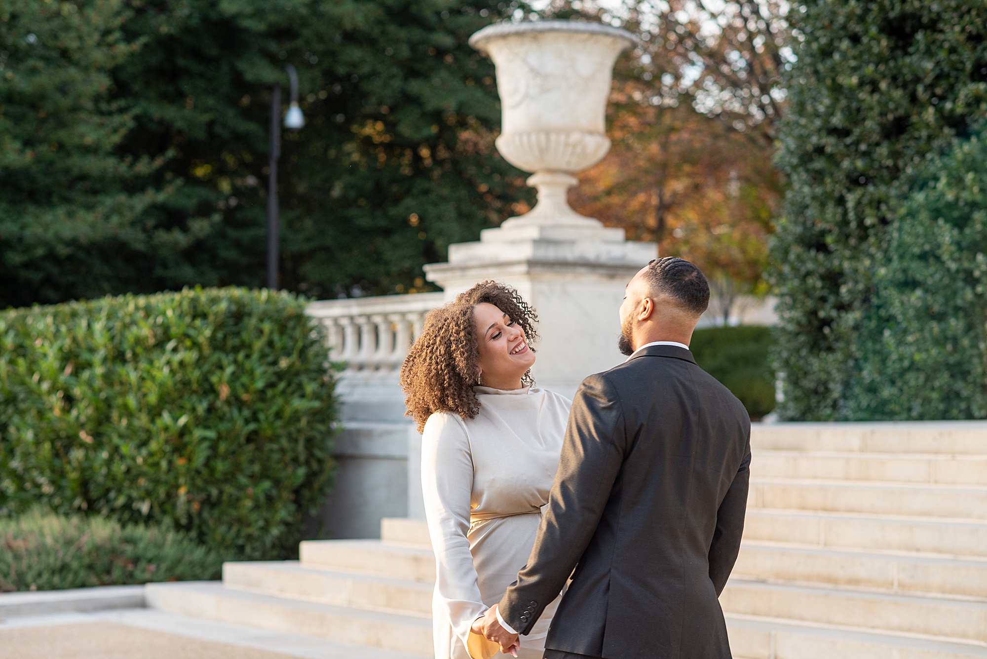 bride and groom laugh together during DC engagement photos 