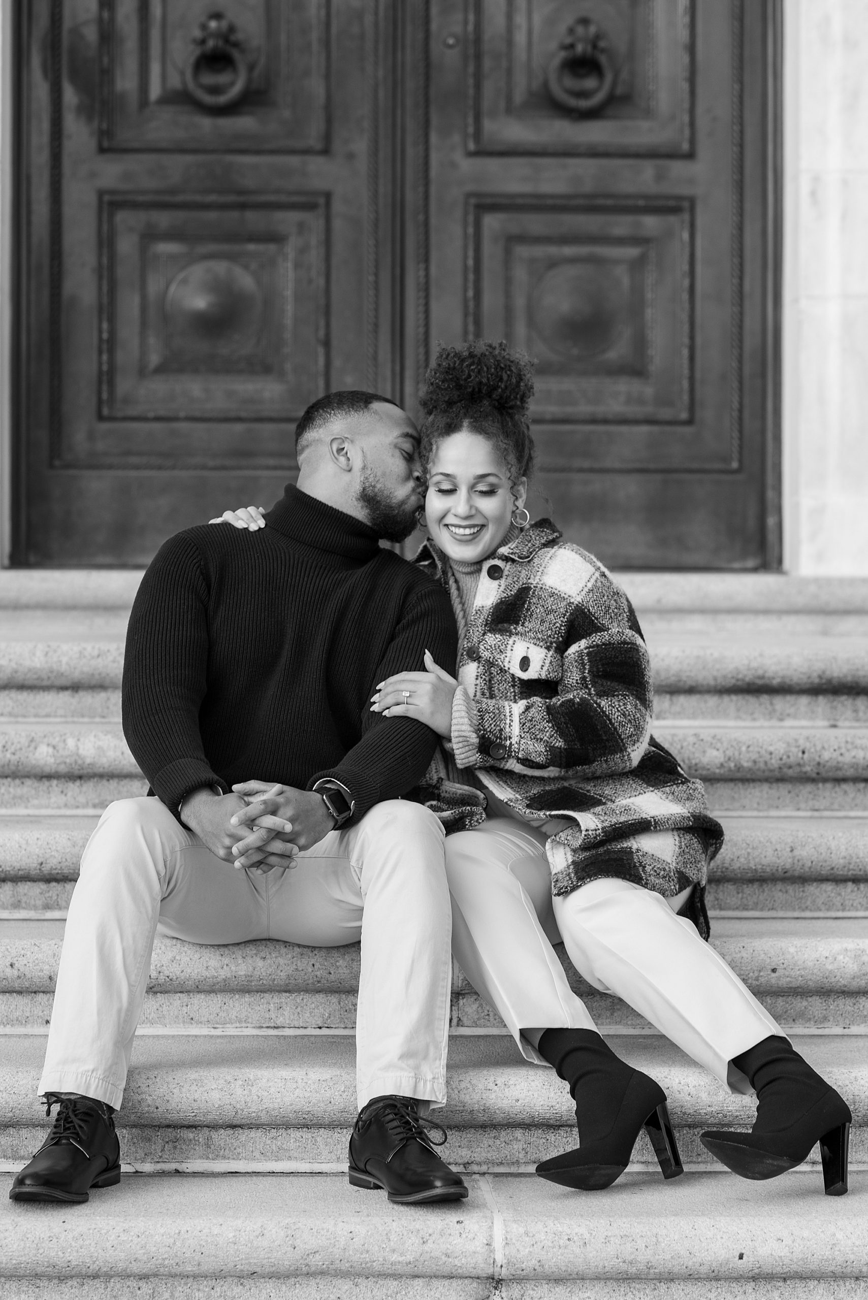 couple sits on steps in DC for chic engagement photos