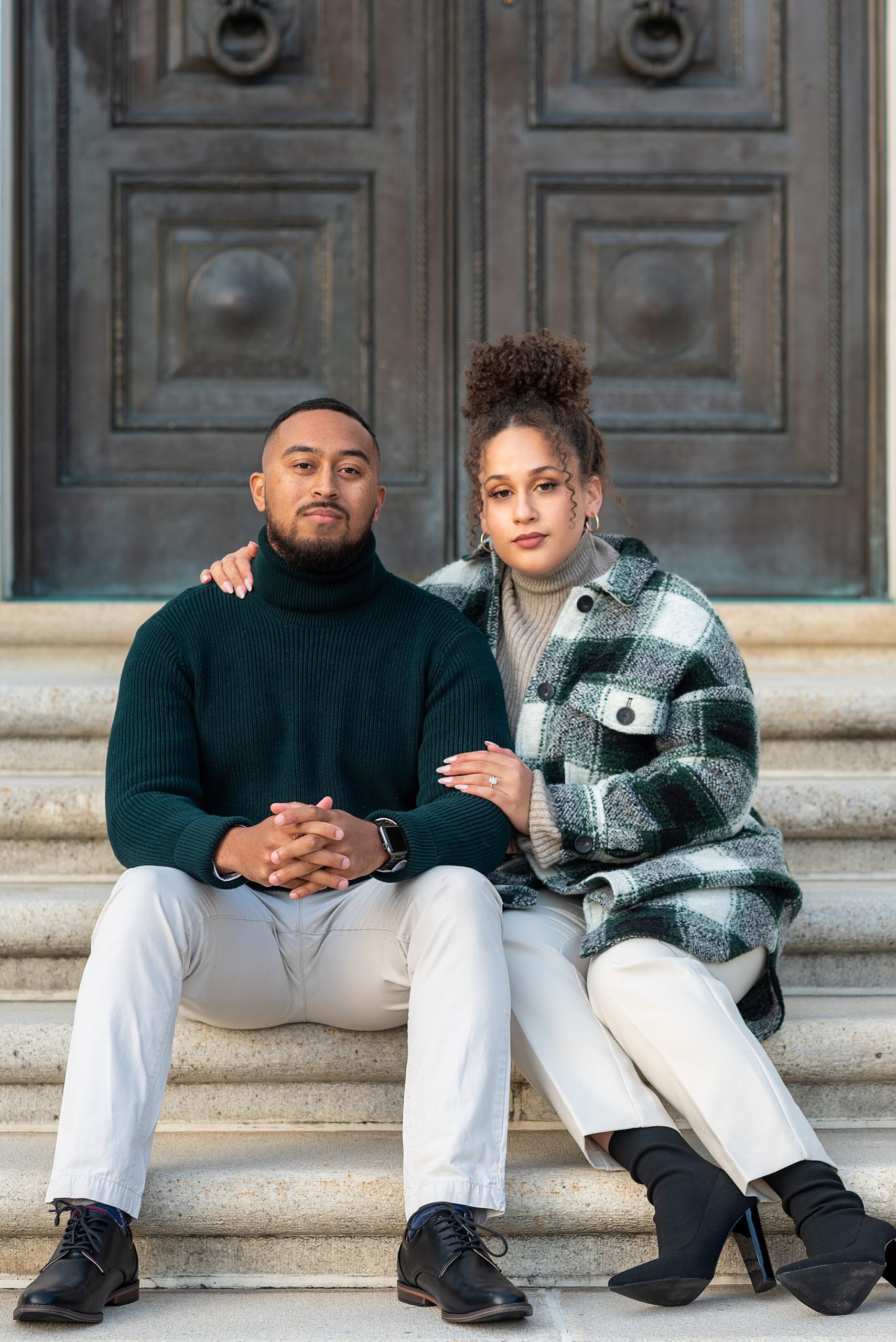 bride and groom sit on steps during DC engagement session