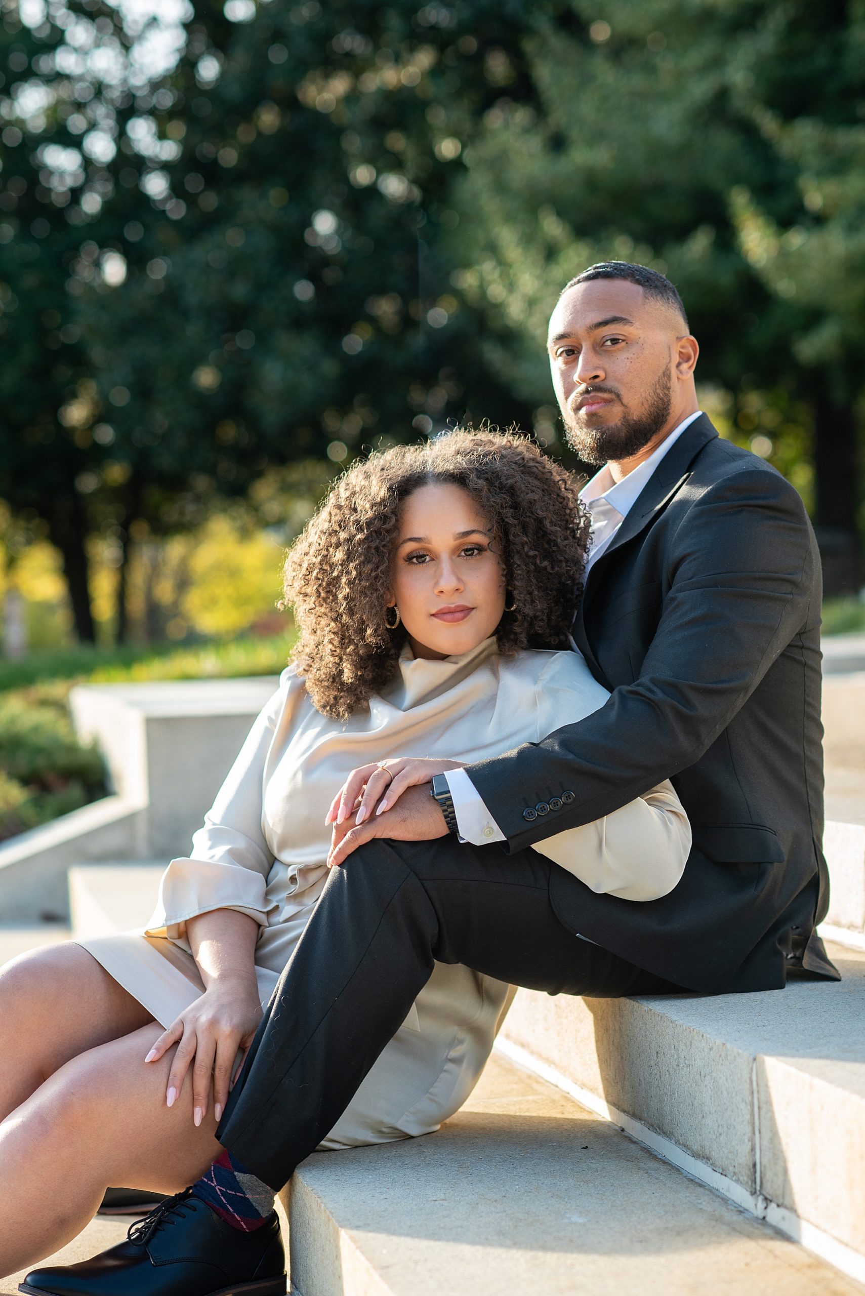 bride and groom sit on steps during American Pharmacist Association engagement session