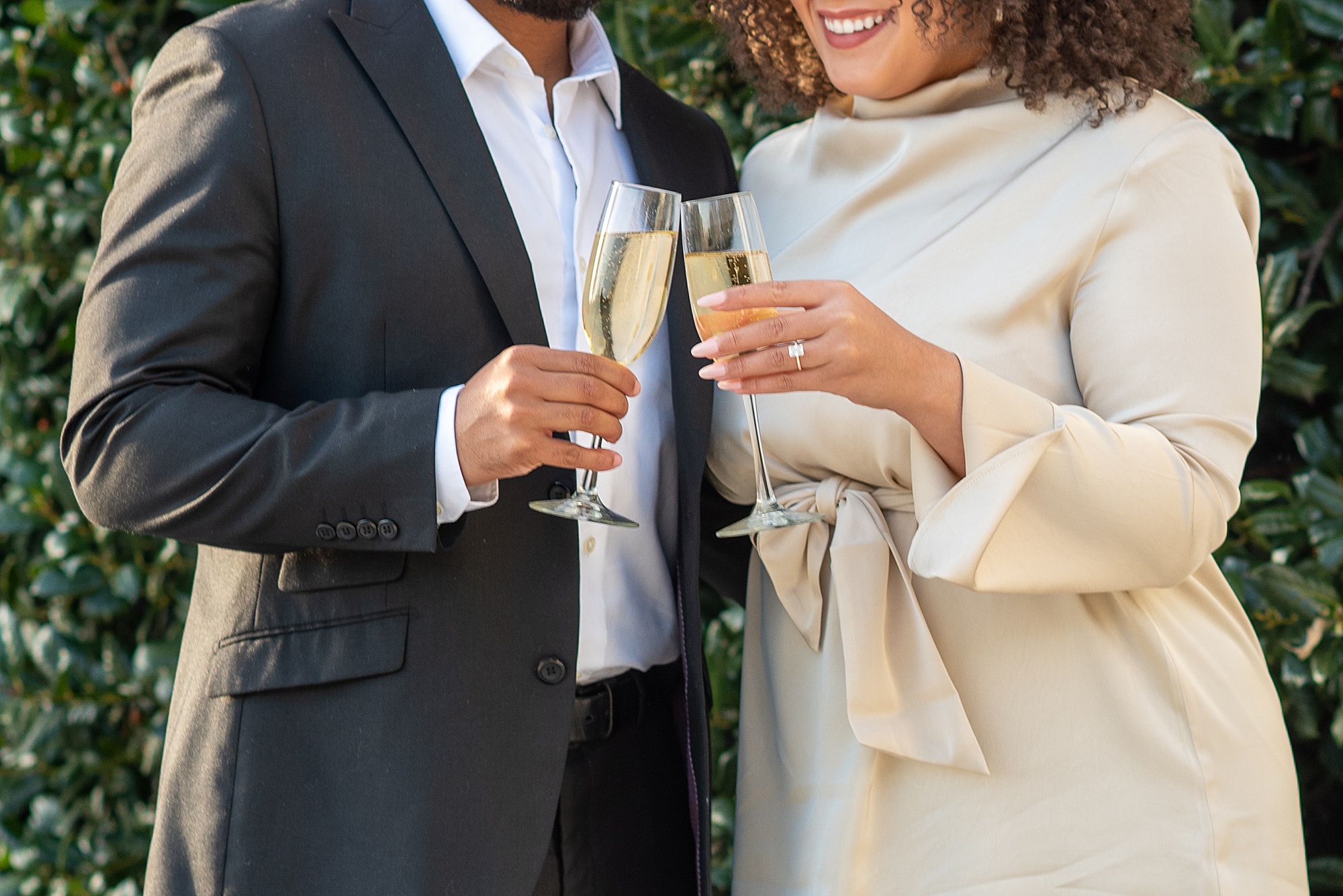 couple toasts champagne during American Pharmacist Association engagementsession