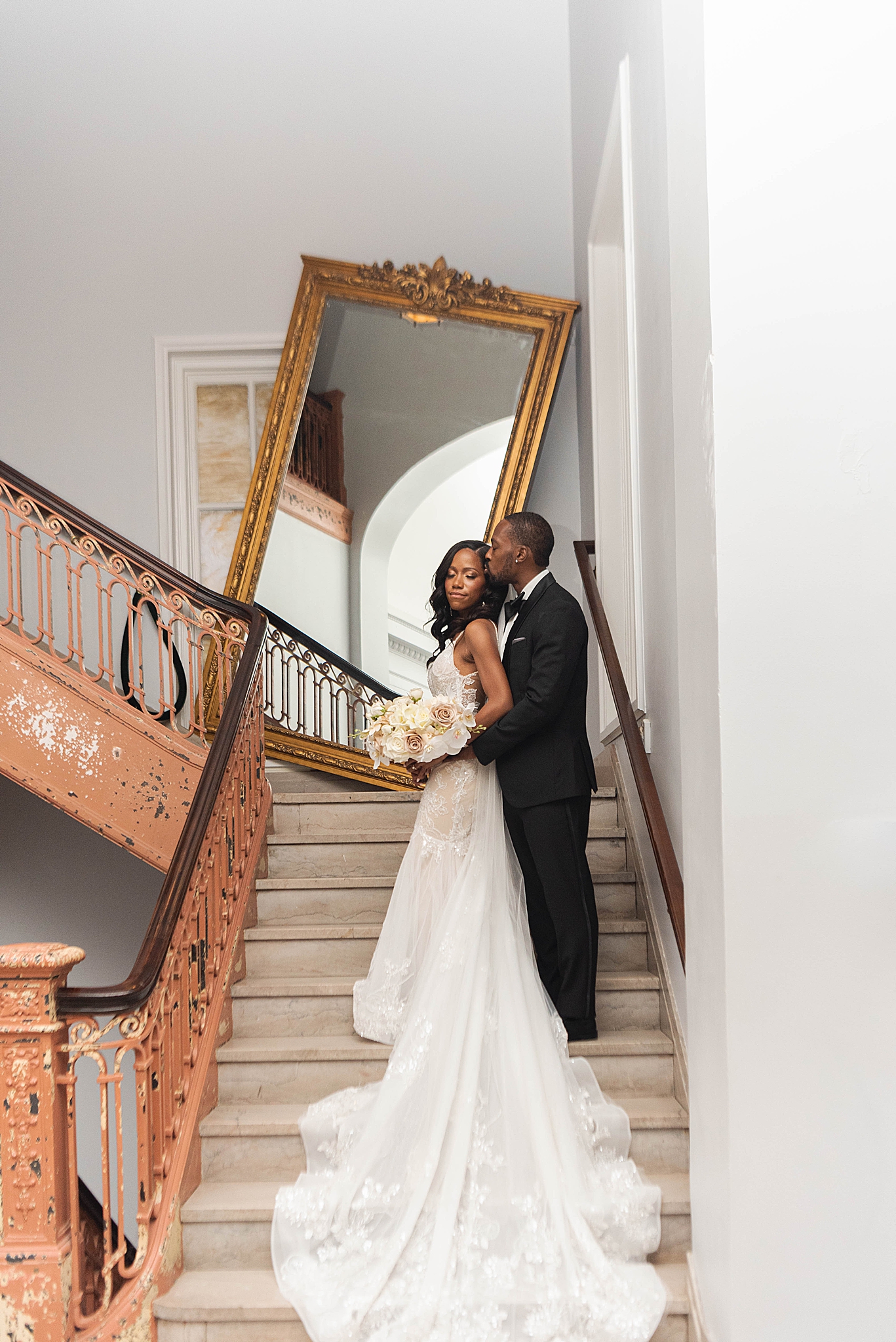couple poses on grand staircase at The LINE Hotel DC