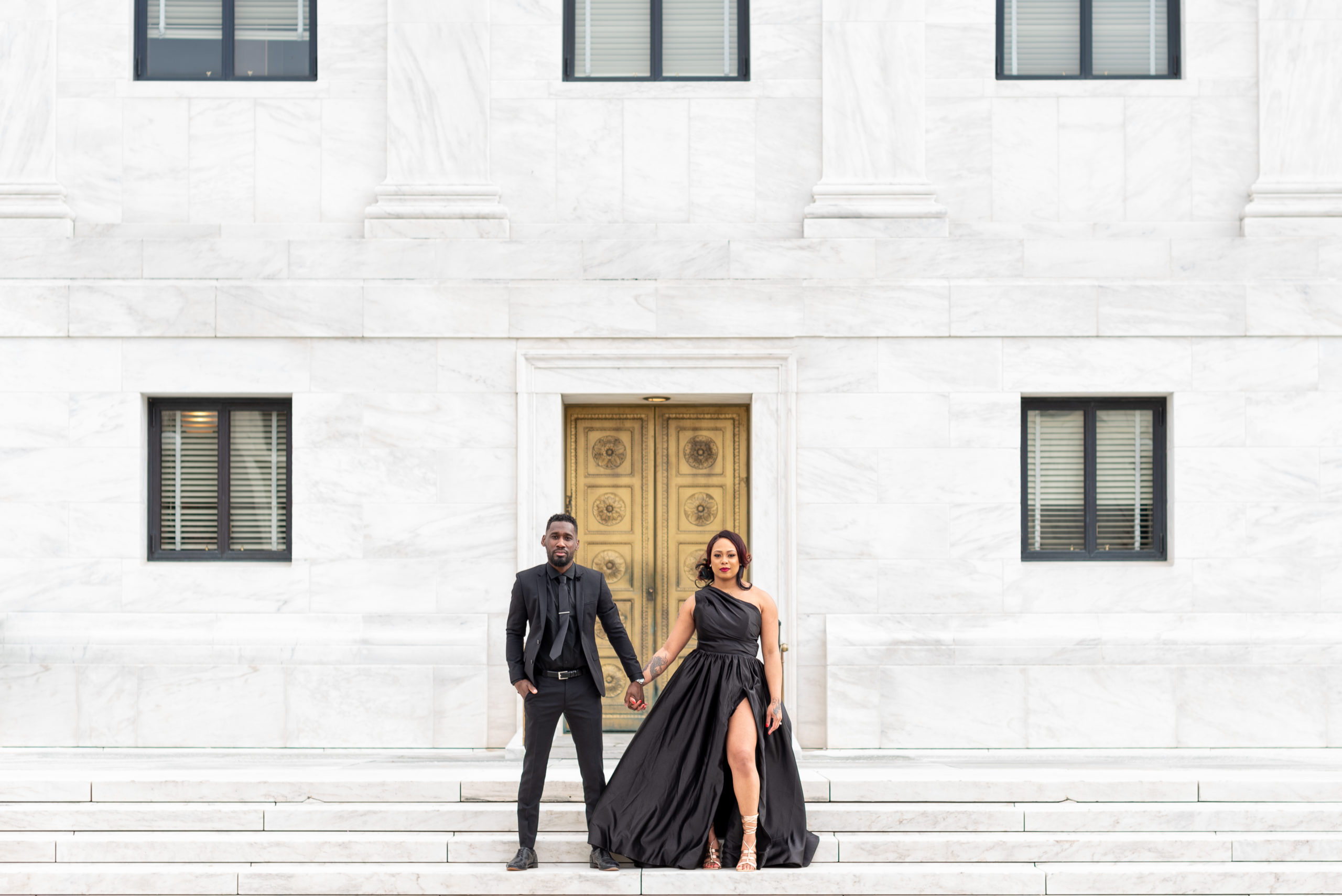 couple posing in front of the supreme court building