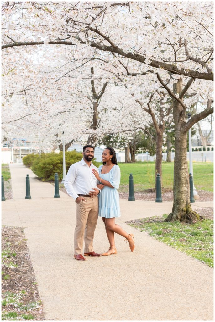 couple standing underneath cherry trees in Washington, D.C.