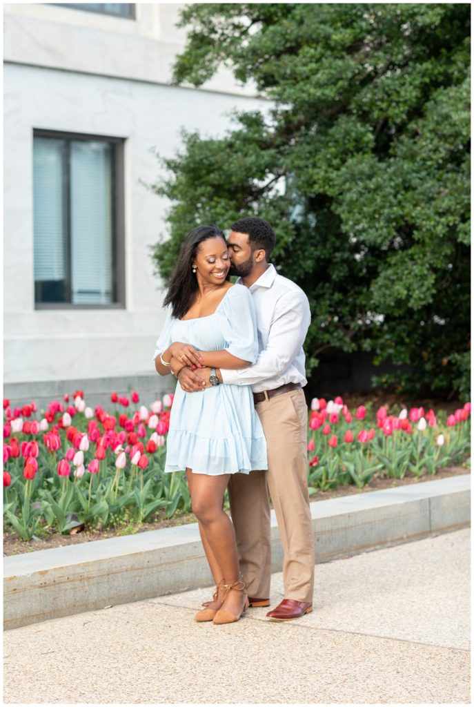 couple kissing in front of tulips in Washington D.C.