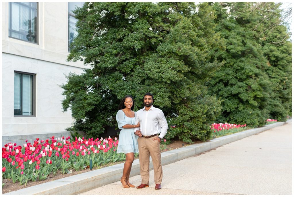 couple posing together next to tulips on the National Mall in D.C.