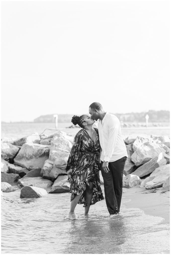 couple kissing standing in the water in Virginia