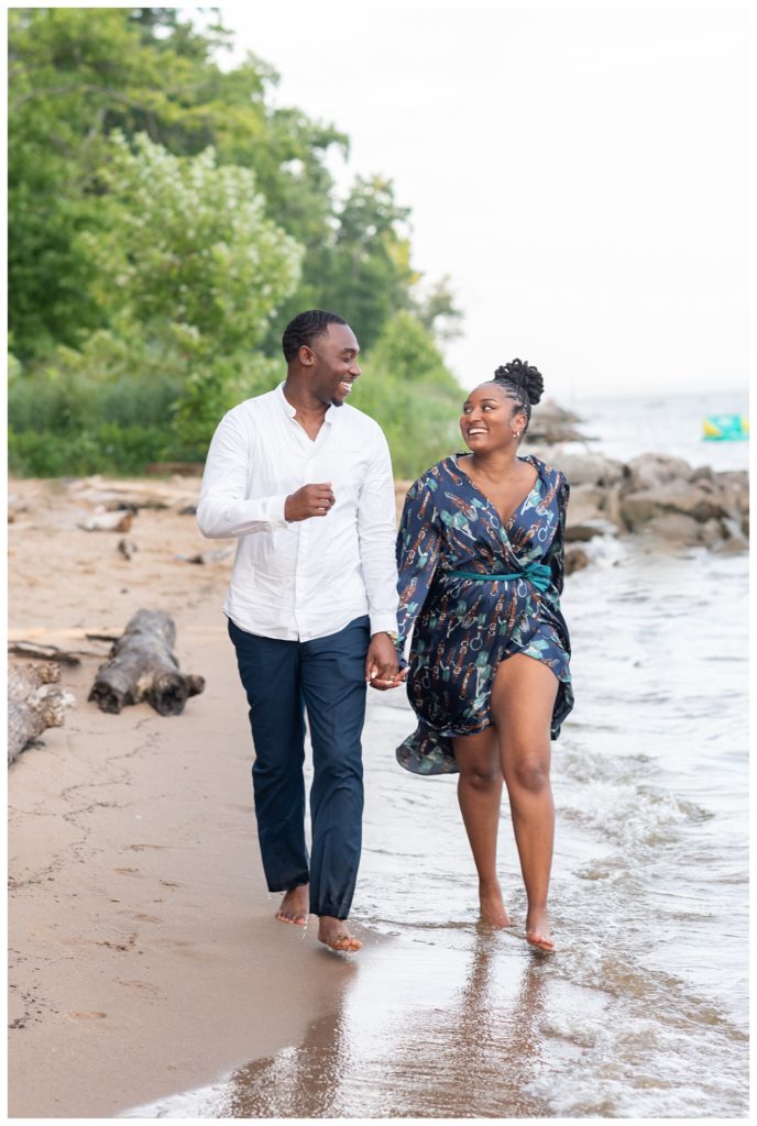 couple running on the sand at Virginia engagement session