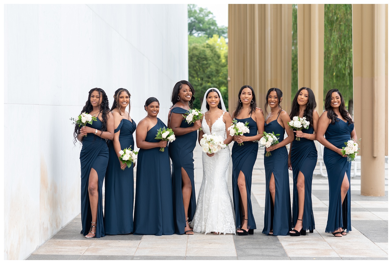 bride posing with her bridesmaids at the Kennedy Center in Washington, D.C.