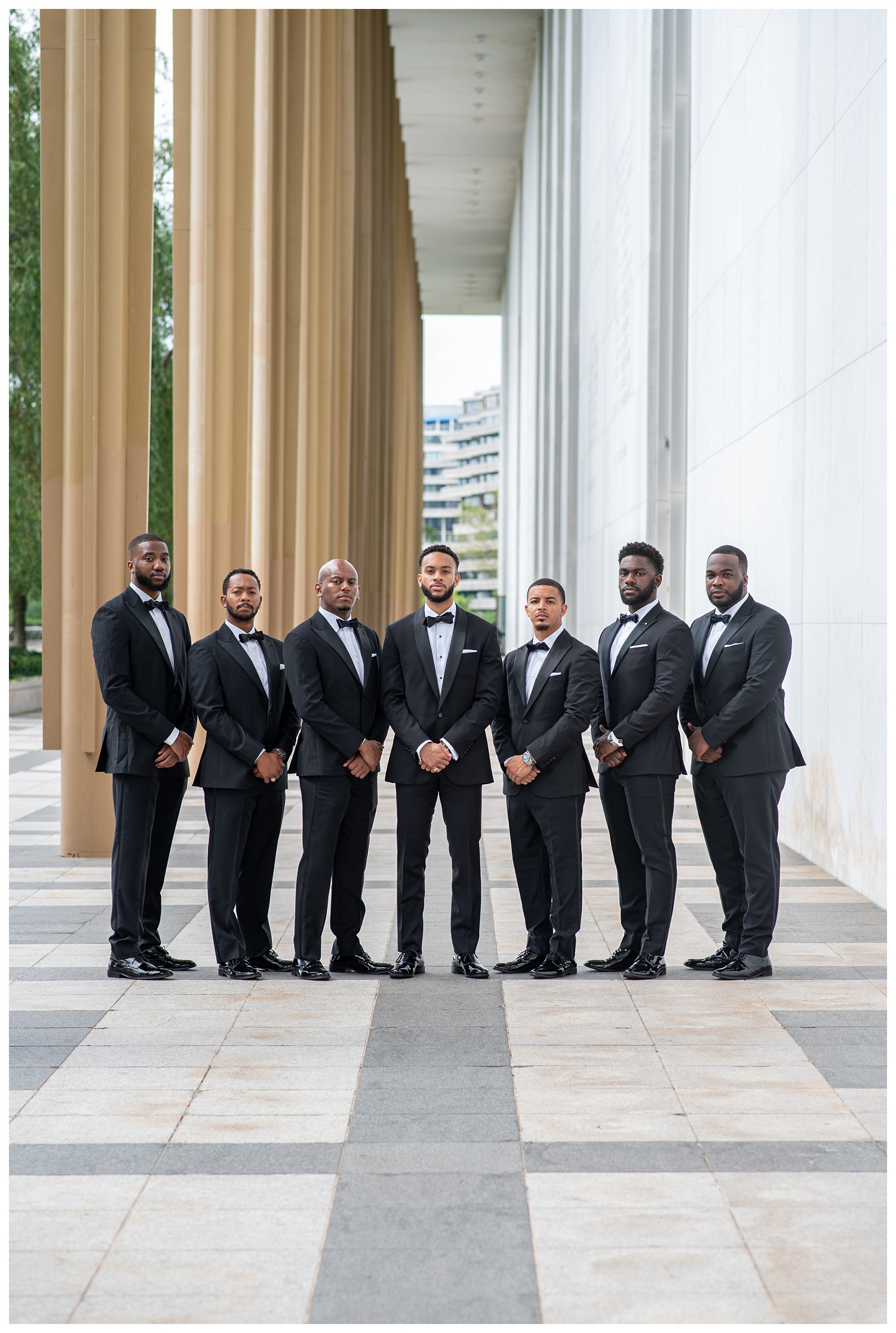 grooms and groomsmen posing together outside in Washington, D.C.