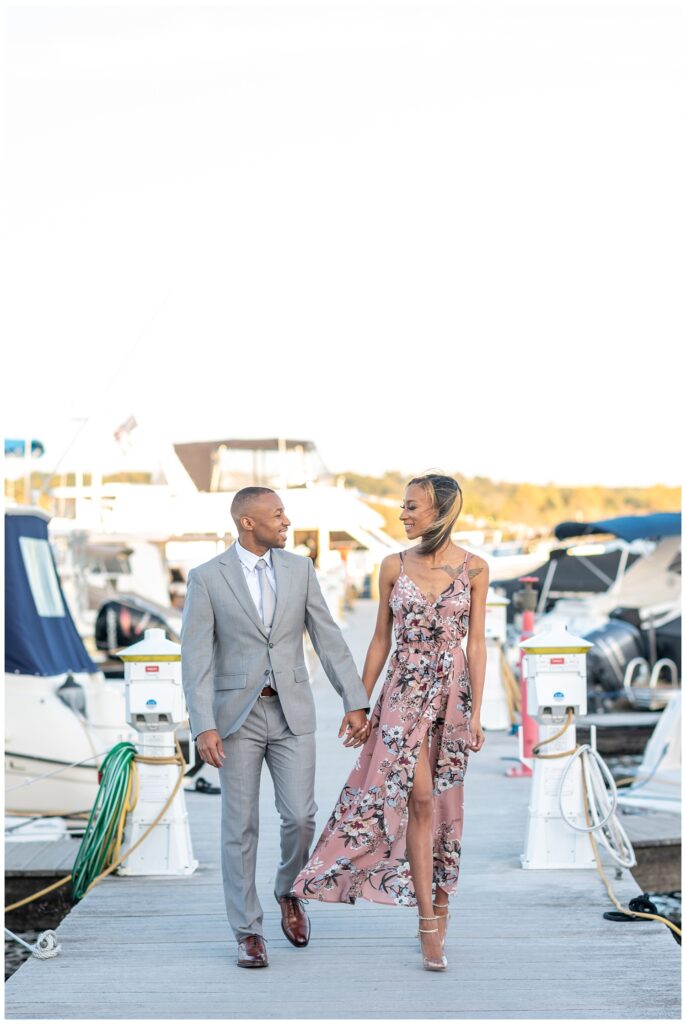 engagement couple walking amid the boats in northern Virginia