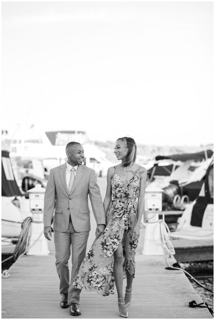 engagement couple walking amid the boats in northern Virginia