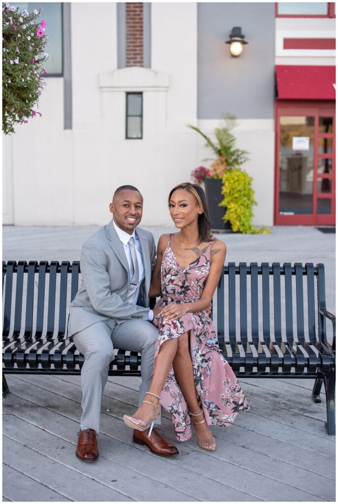 couple sitting on a bench for engagement pictures in northern Virginia