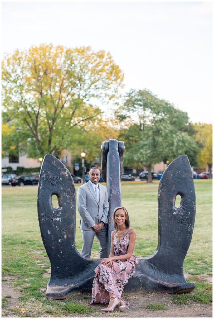 couple posing amid a sculpture for Old Town Alexandria engagement pictures