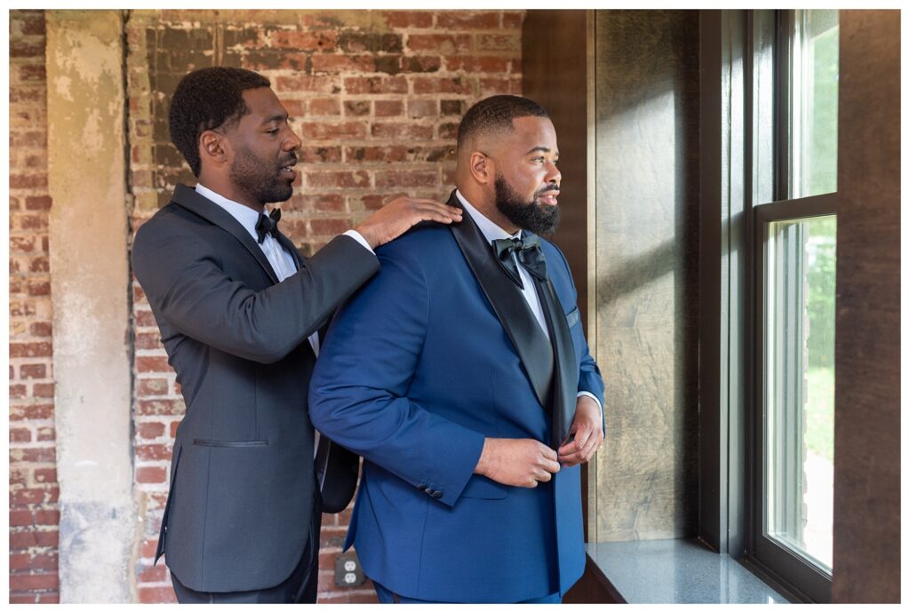 groom adjusting his black and blue tuxedo at D.C. wedding venue