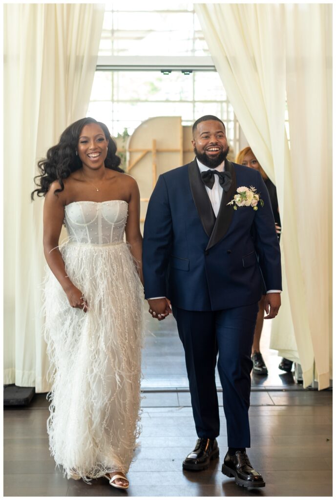bride and groom walking into wedding reception in Virginia 