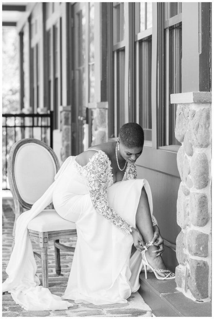 bride putting on shoes at Maryland wedding venue