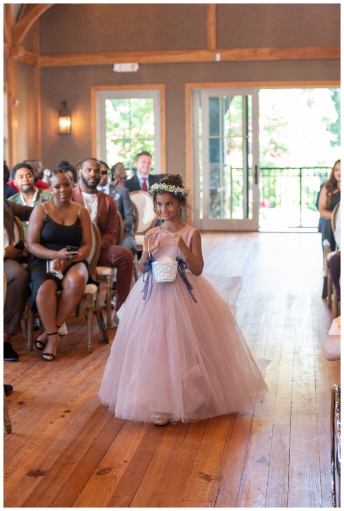 flower girl walking down the aisle at Maryland wedding ceremony