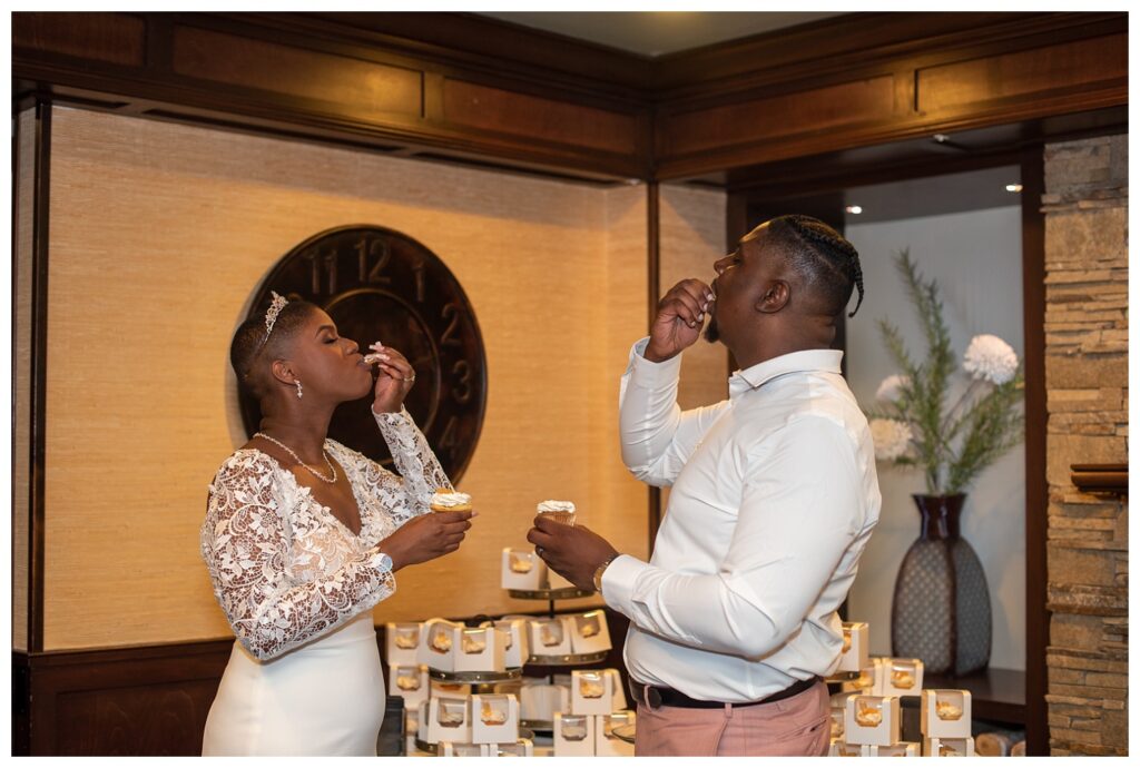 bride and groom eating cupcakes at wedding reception in Maryland