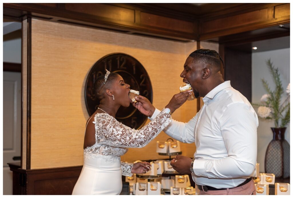 bride and groom feeding each other cupcakes at wedding reception in Maryland