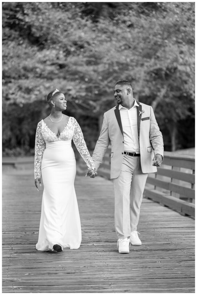 bride and groom walking on the bridge at the Golf Club at South River