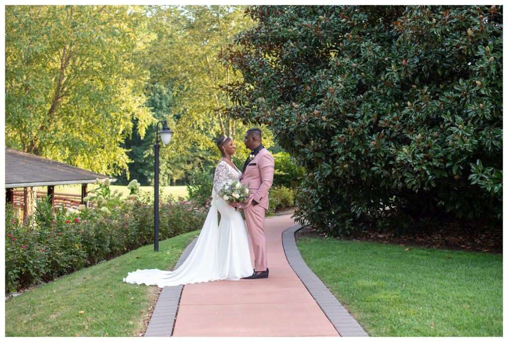 bride and groom posing on the sidewalk at Maryland venue