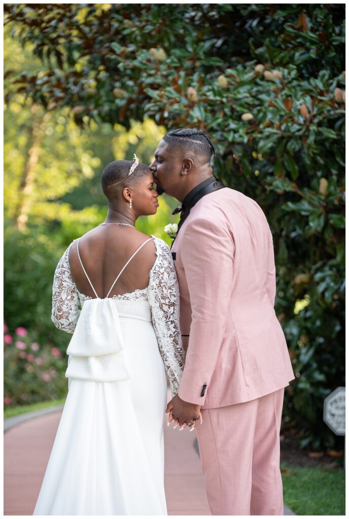 groom kissing the bride's forehead at Maryland wedding