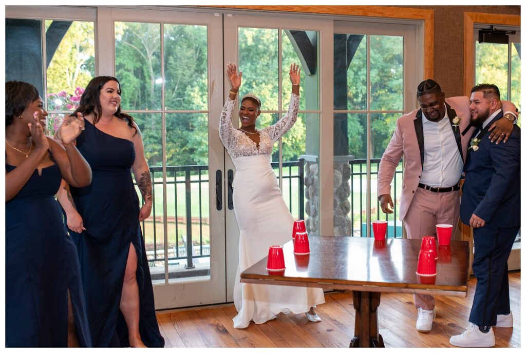 wedding party playing flip cup at reception in Maryland