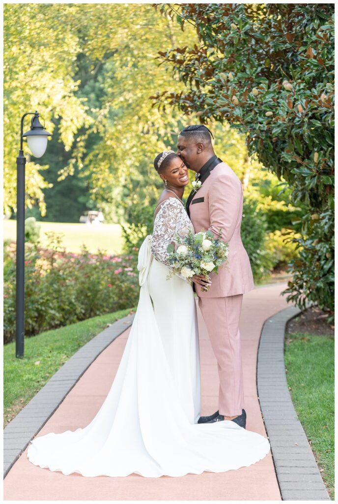 bride and groom posing on the sidewalk at Maryland wedding venue